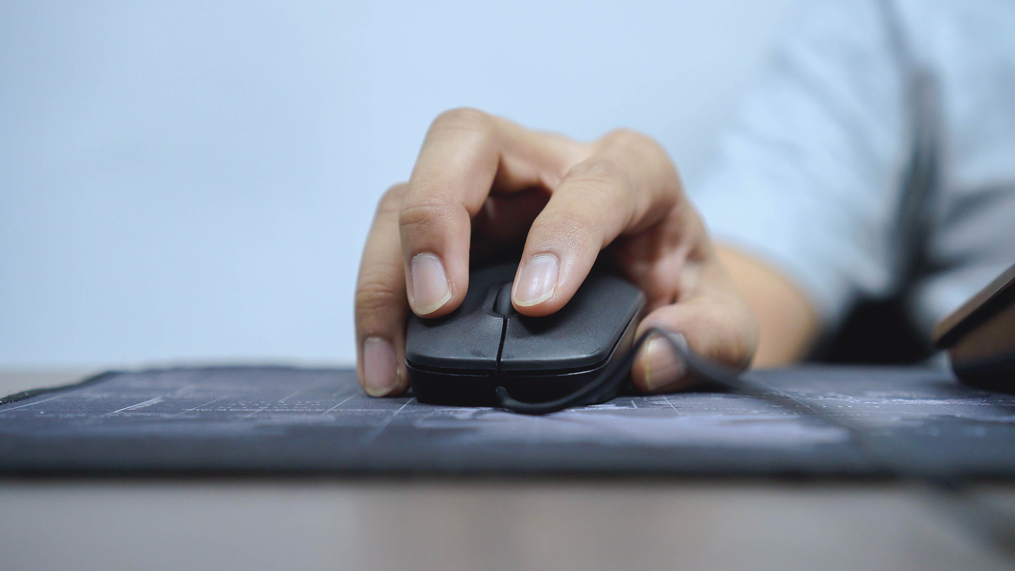 a hand on a computer mouse