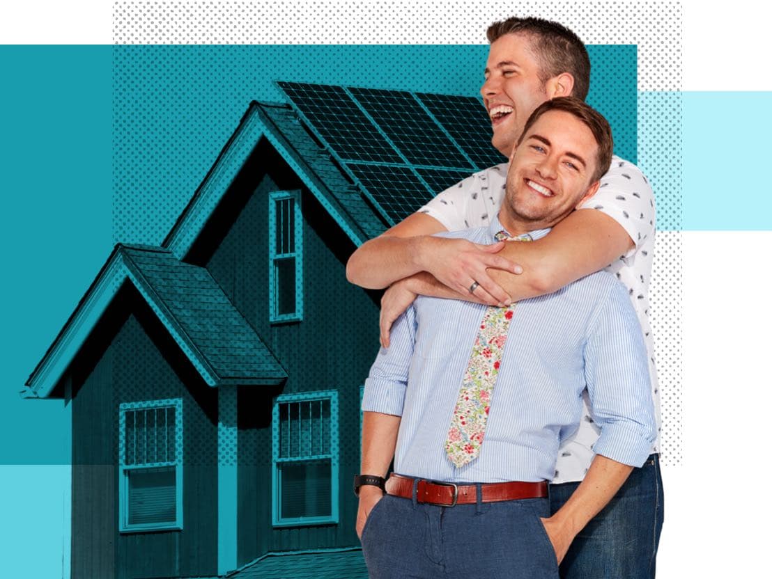 Aaron & Jake, Affinity Plus members, hugging in front of a home with solar panels.