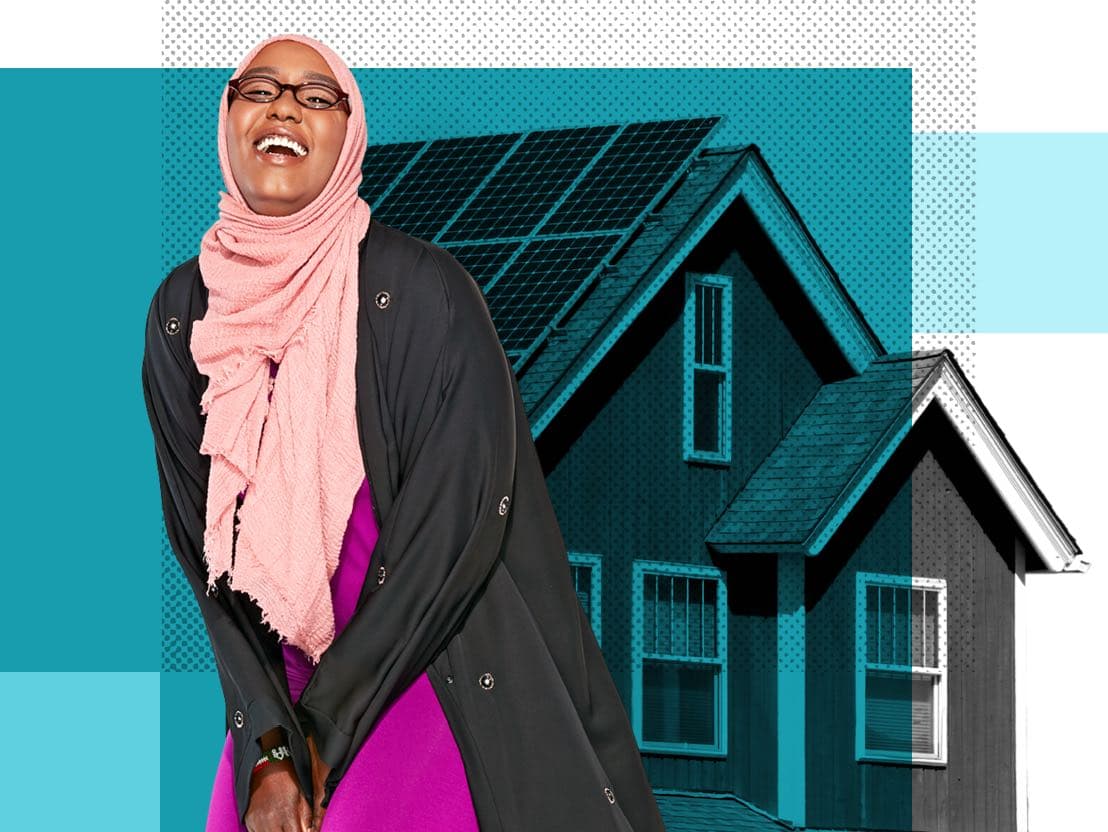 Asah, a Minnesota resident, in front of a home with solar panels.