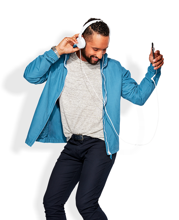 A man in a blue hoodie dances while listening to headphones
