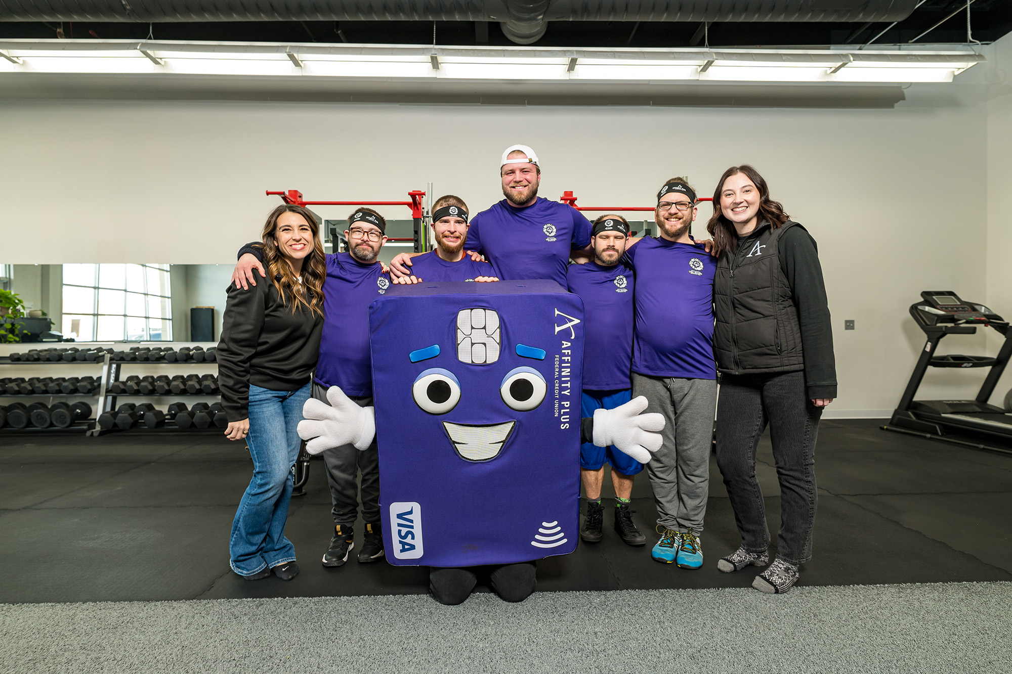 Special Olympics Powerlifting athletes with Affinity Plus employees and Chip mascot