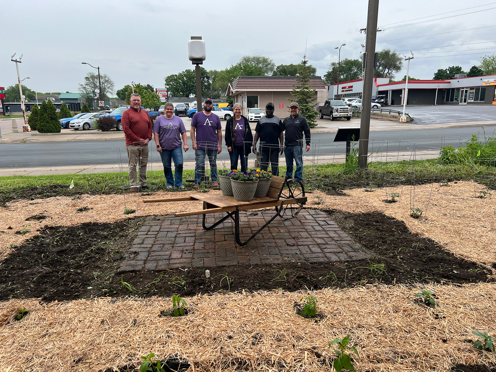 a group of people standing in the back of a garden