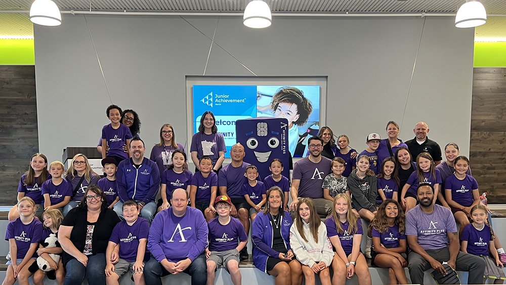 A large group of kids and parents wearing purple