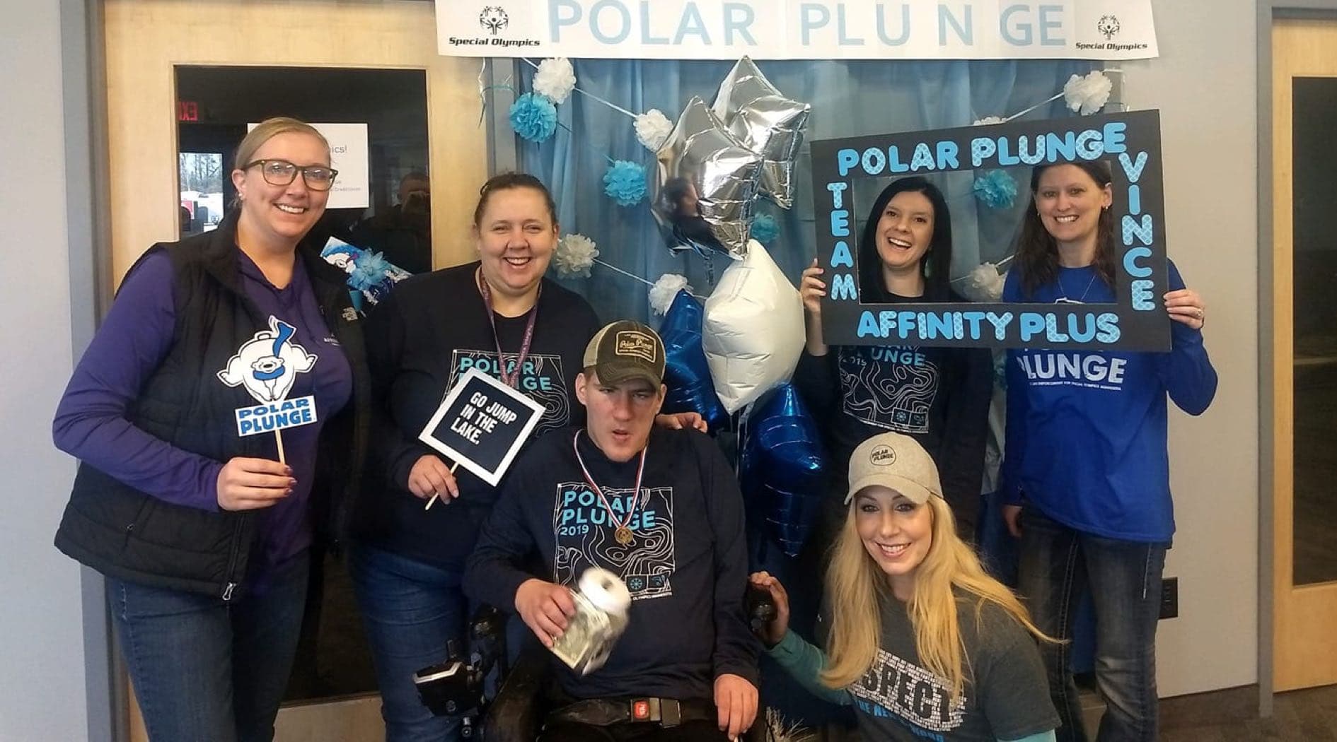 A group of Affinity Plus employees wearing Polar Plunge T-shirts