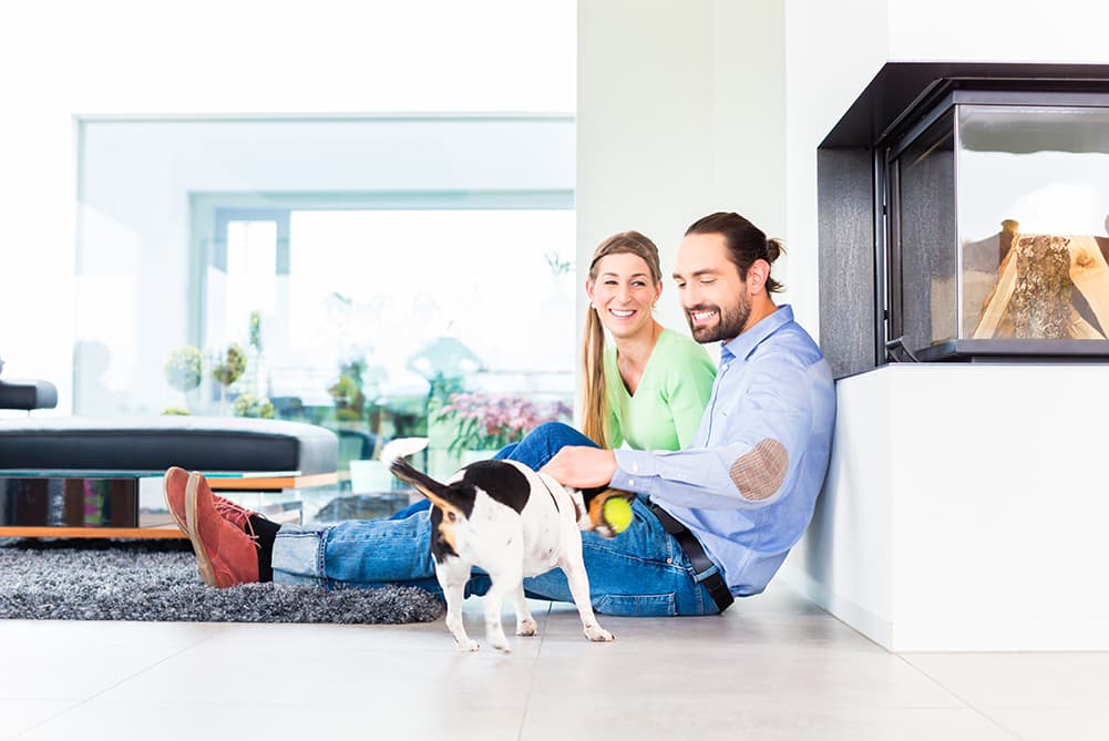 Couple with dog inside house