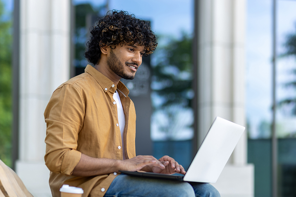 a young man looking at a computer