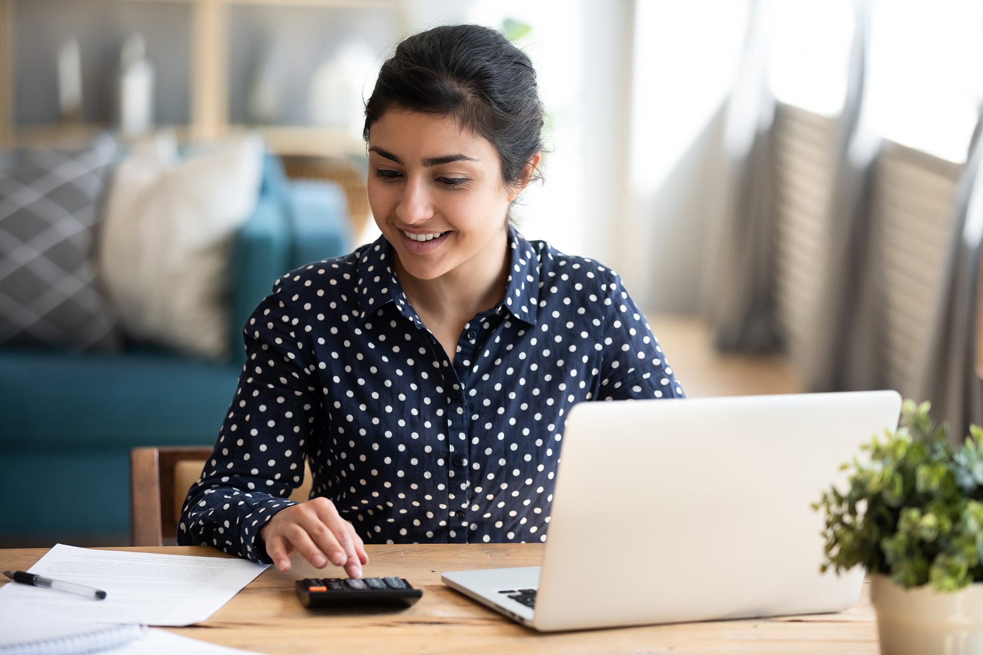 A woman with a calculator and computer