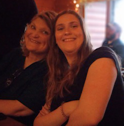 a mother & daughter smiling