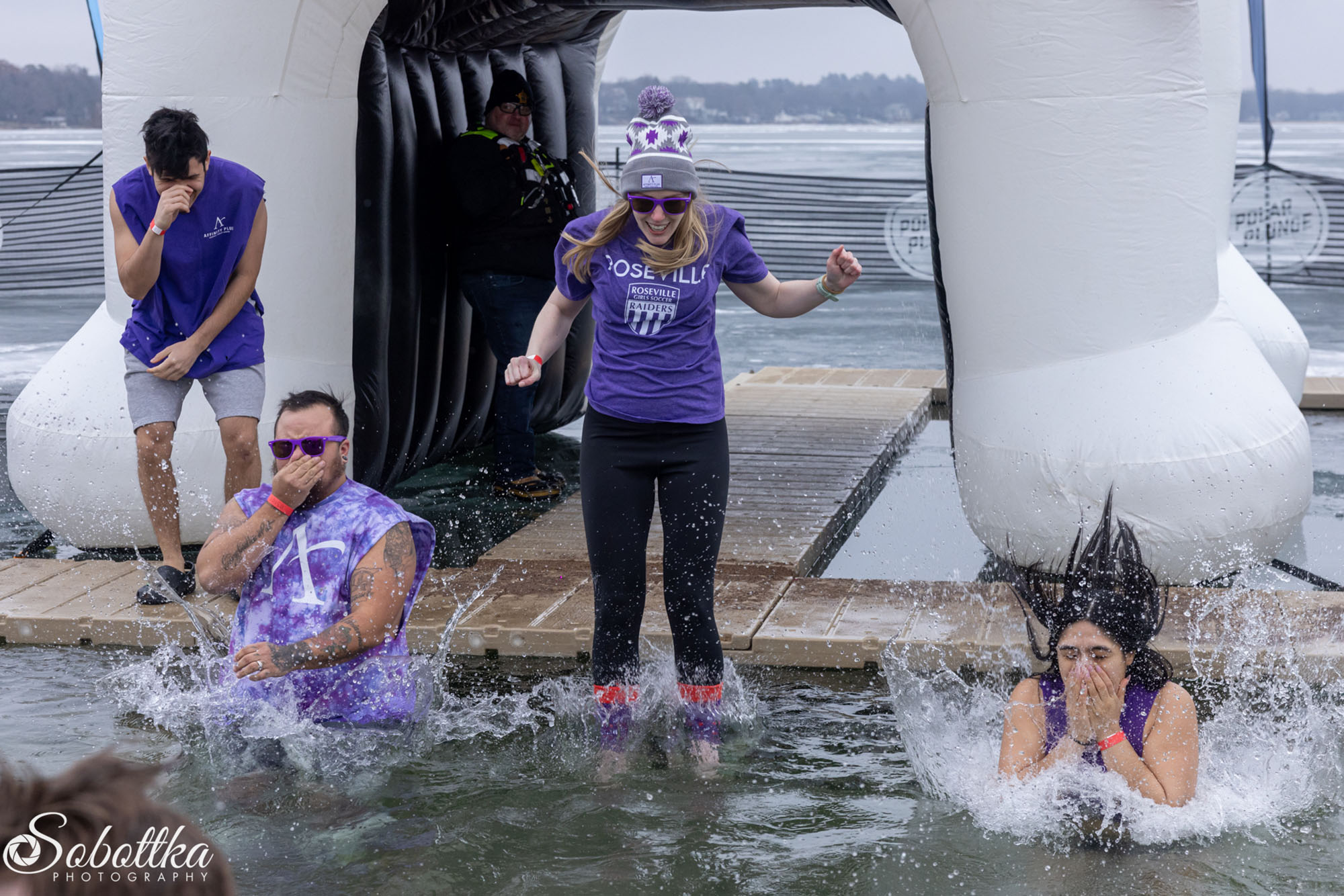a group umping into a lake