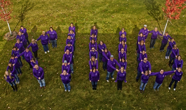 Affinity Plus employees in a "KIND" formation