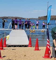 group of people ready to jump in to a lake