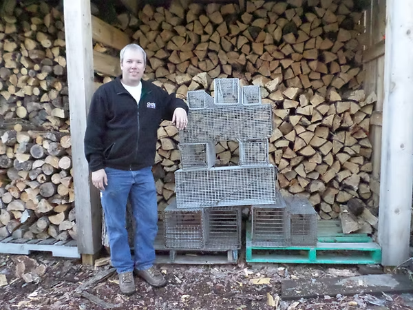 A man standing in front of cages