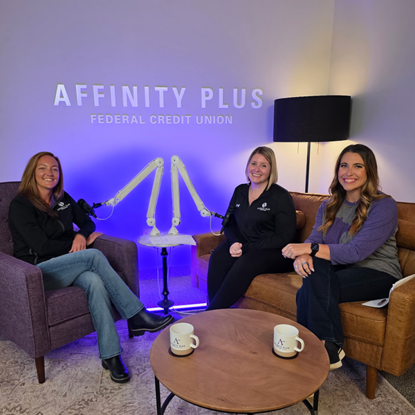 3 women smiling in a podcast studio