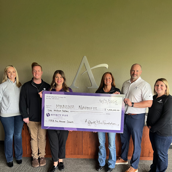 A group of people holding a check to Minnesota Nonprofits for $1 million dollars