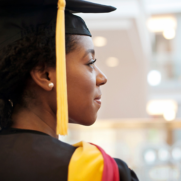 A woman wearing graduate cap and gown