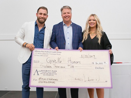 three people with large check